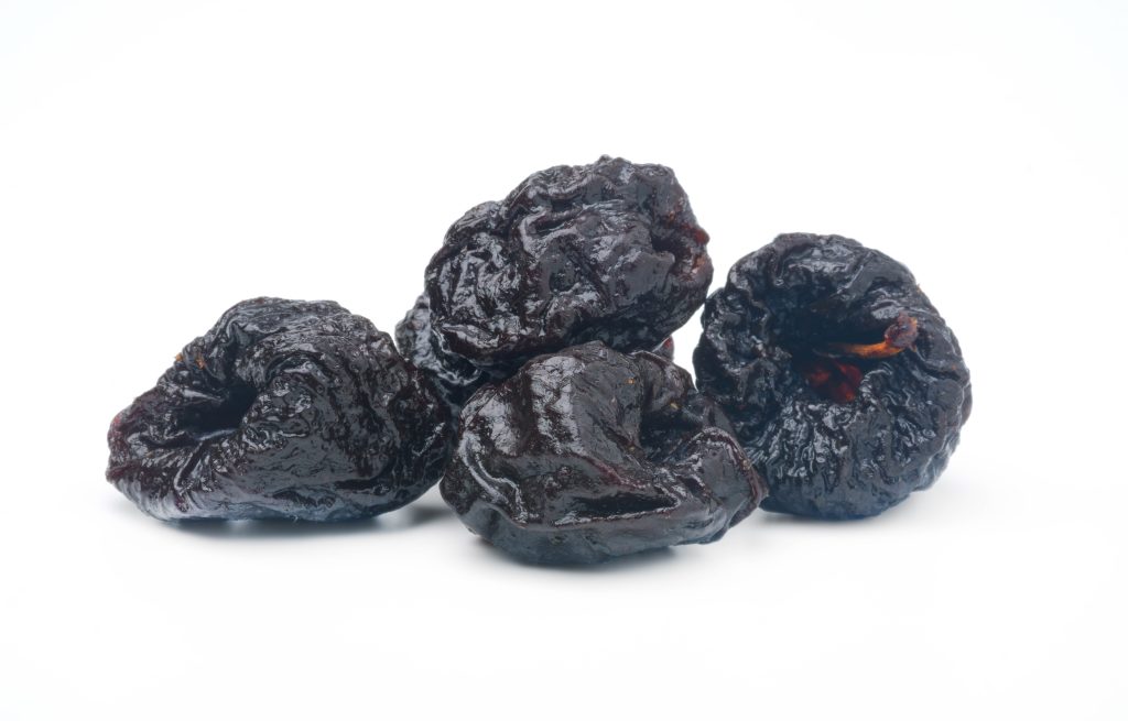 dried prunes isolated white backgroundmany useful fruits